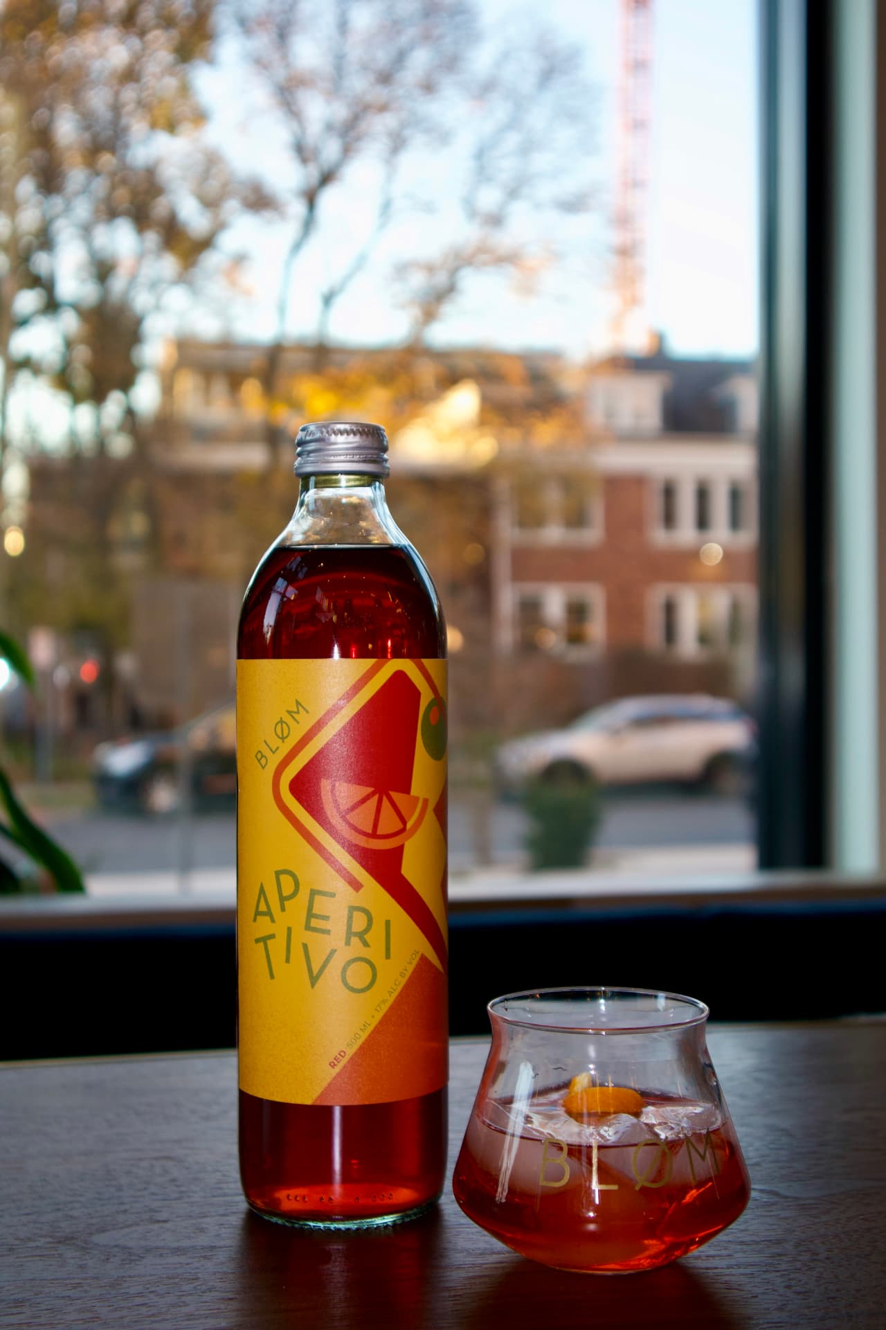 Bløm Aperitivo bottle and glass by the taproom window