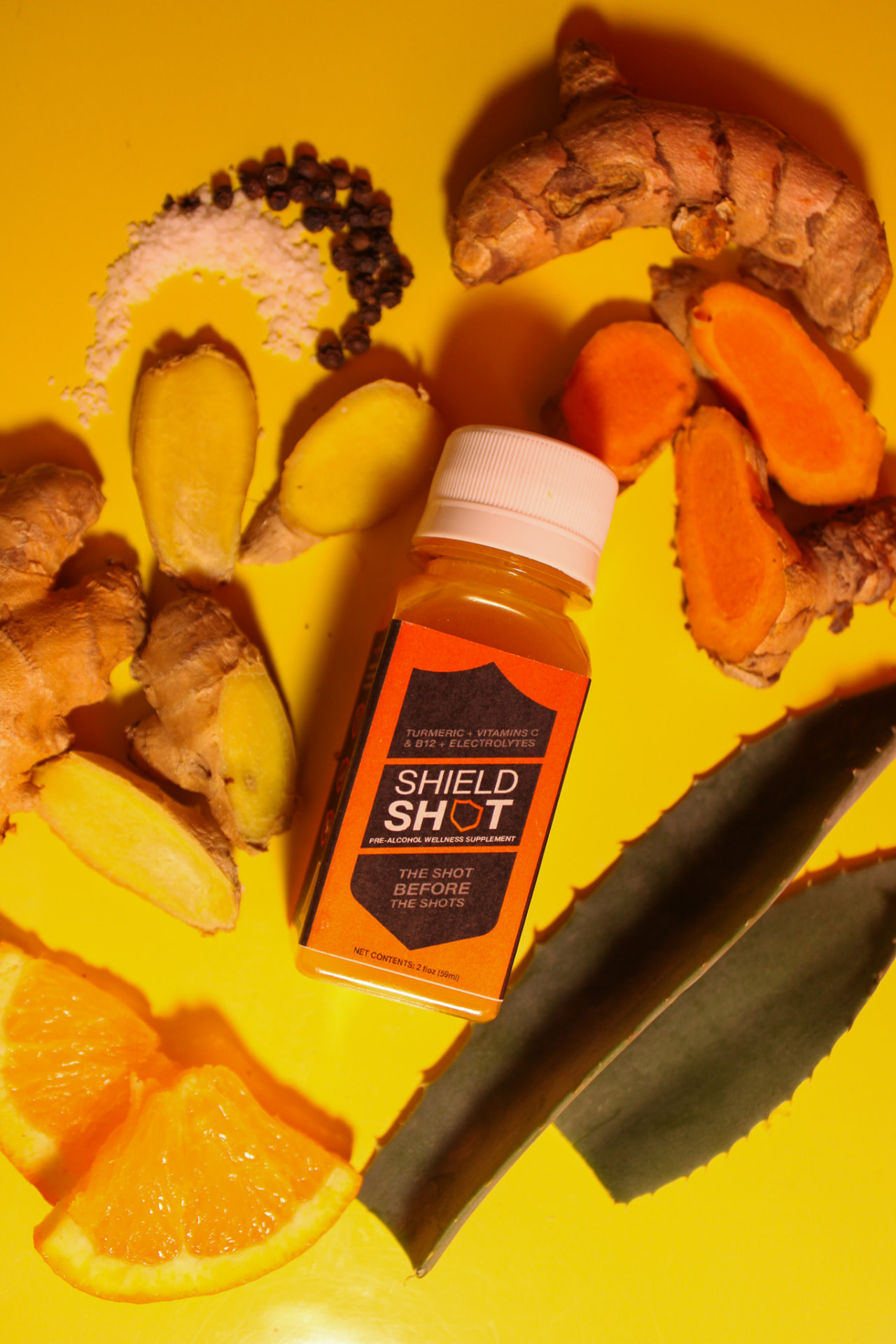 Flat lay of ShieldShot with ginger, turmeric and aloe