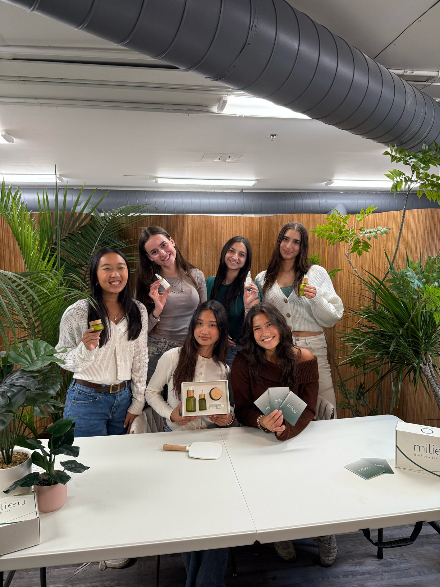 MAM team holding Milieu skincare products
