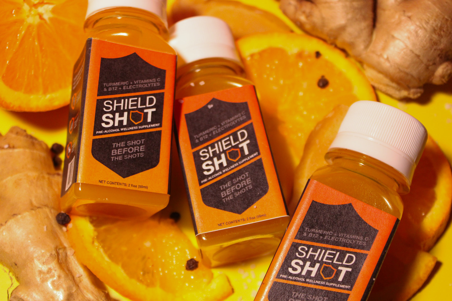Three ShieldShot bottles on citrus