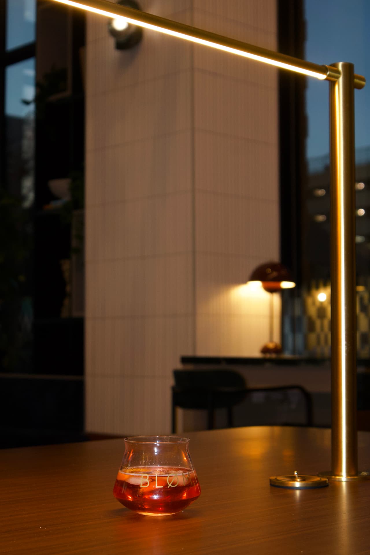 Bløm glass on a taproom table at dusk